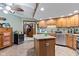 Cozy kitchen featuring a center island with granite countertops, wine cooler, and ample storage at 6980 White Oak Dr, Avon, IN 46123