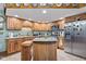 Inviting kitchen with stainless appliances, granite countertops, and natural wood cabinetry at 6980 White Oak Dr, Avon, IN 46123