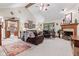 Cozy living room with a fireplace, vaulted ceilings, and comfortable seating, perfect for relaxing at 6980 White Oak Dr, Avon, IN 46123