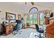 Bright home office with vaulted ceilings and large windows overlooking the front yard at 6980 White Oak Dr, Avon, IN 46123