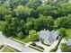 An aerial view displays the home's location amongst lush greenery and manicured landscaping at 7106 Royal Oakland Dr, Indianapolis, IN 46236