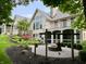 Expansive backyard featuring lush landscaping, fire pit, upper and lower patios, and beautiful home architecture at 7106 Royal Oakland Dr, Indianapolis, IN 46236