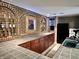 Entertain in this home's bar that features tile countertops, unique decor, shelving, and storage space at 7106 Royal Oakland Dr, Indianapolis, IN 46236