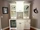 Stylish home bar with built-in shelves, white cabinets, and a mini-fridge at 7106 Royal Oakland Dr, Indianapolis, IN 46236