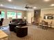 This finished basement features multiple leather couches, ceiling fan and staircase to the upper floor at 7106 Royal Oakland Dr, Indianapolis, IN 46236