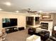 This finished basement features a fireplace, ceiling fan, wet bar and media center at 7106 Royal Oakland Dr, Indianapolis, IN 46236