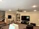 This finished basement features a staircase, media center, furniture and gaming area at 7106 Royal Oakland Dr, Indianapolis, IN 46236