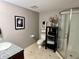 Functional bathroom with a tiled floor, glass-enclosed shower, and ample storage space, providing a clean and organized area at 7106 Royal Oakland Dr, Indianapolis, IN 46236