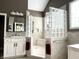 Well-lit bathroom with a glass block shower and white cabinets at 7106 Royal Oakland Dr, Indianapolis, IN 46236