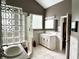Spacious bathroom featuring glass block shower, white vanity, and neutral tile at 7106 Royal Oakland Dr, Indianapolis, IN 46236