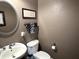 Cozy half bathroom with modern fixtures and a decorative mirror at 7106 Royal Oakland Dr, Indianapolis, IN 46236
