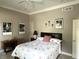 Neutral bedroom with modern art prints and vintage sewing table decor at 7106 Royal Oakland Dr, Indianapolis, IN 46236