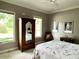 Cozy bedroom with two windows, wood accents, and carpet at 7106 Royal Oakland Dr, Indianapolis, IN 46236