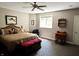 Comfortable bedroom features a ceiling fan, natural light, and carpeted flooring, creating a tranquil space at 7106 Royal Oakland Dr, Indianapolis, IN 46236