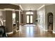 Inviting entryway features hardwood floors, a statement rug, double doors, and views into dining area at 7106 Royal Oakland Dr, Indianapolis, IN 46236