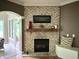 Living room featuring a brick fireplace with a wooden mantel and decorative accents at 7106 Royal Oakland Dr, Indianapolis, IN 46236