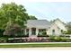 Inviting exterior showcasing the home's manicured lawn, charming facade, and lush greenery at 7106 Royal Oakland Dr, Indianapolis, IN 46236