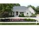 Charming home with stone accents, a well-manicured lawn, and inviting curb appeal at 7106 Royal Oakland Dr, Indianapolis, IN 46236