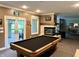 This home's basement is built for entertainment with a pool table, fireplace, and outdoor access at 7106 Royal Oakland Dr, Indianapolis, IN 46236