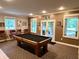 Finished basement game room includes a pool table, access to the outdoors, and natural light at 7106 Royal Oakland Dr, Indianapolis, IN 46236