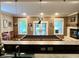 This home's entertainment space features a wet bar, pool table, fireplace, and plenty of room to enjoy at 7106 Royal Oakland Dr, Indianapolis, IN 46236
