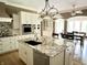 Open concept kitchen featuring an island with bar seating and modern appliances at 7106 Royal Oakland Dr, Indianapolis, IN 46236