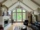 Bright living room features vaulted ceilings, fireplace and large picture window offering views of the landscaped backyard at 7106 Royal Oakland Dr, Indianapolis, IN 46236