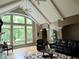 Spacious living room boasts vaulted ceilings, large window, and comfortable seating arrangements with a view to the outside at 7106 Royal Oakland Dr, Indianapolis, IN 46236