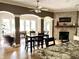 Living room with brick fireplace, hardwood floors, and arched doorways to a sunroom at 7106 Royal Oakland Dr, Indianapolis, IN 46236