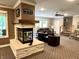 Open living room boasts a stone fireplace, recessed lights, ceiling fan, neutral paint, and plush carpet at 7106 Royal Oakland Dr, Indianapolis, IN 46236