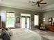 Bright main bedroom with a trey ceiling, access to balcony, and large windows at 7106 Royal Oakland Dr, Indianapolis, IN 46236
