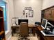 Home office featuring dark wood furnishings, built in storage and a large window at 7106 Royal Oakland Dr, Indianapolis, IN 46236