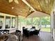 Picture of a screened-in porch with wood ceiling, recessed lights, and outdoor seating with a view of the backyard at 7106 Royal Oakland Dr, Indianapolis, IN 46236