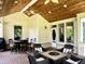 Outdoor screened-in porch with wood ceiling, recessed lights and outdoor dining, perfect for relaxing and entertaining at 7106 Royal Oakland Dr, Indianapolis, IN 46236