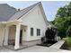 Exterior showing the home's side elevation, well-maintained siding, and professional landscaping at 7106 Royal Oakland Dr, Indianapolis, IN 46236