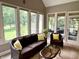 Inviting sunroom with comfortable seating, neutral tones, and abundant natural light at 7106 Royal Oakland Dr, Indianapolis, IN 46236