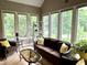 Bright and airy sunroom with multiple windows, comfortable seating, and serene outdoor views at 7106 Royal Oakland Dr, Indianapolis, IN 46236