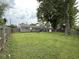 Spacious backyard with a lush lawn, a gray brick house, and a tree that provides plenty of shade at 729 Maple Ln, Brownsburg, IN 46112