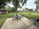 The backyard patio offers outdoor dining with views of a green, fenced yard and a fire pit at 729 Maple Ln, Brownsburg, IN 46112
