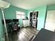 Charming bedroom with gray wood floors, a closet, and an eye-catching light teal paint at 729 Maple Ln, Brownsburg, IN 46112
