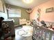 Adorable Bedroom features a decorative rug, cot, and ample natural light at 729 Maple Ln, Brownsburg, IN 46112