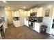 Bright kitchen with stainless steel appliances, white cabinets and ceramic tile flooring at 729 Maple Ln, Brownsburg, IN 46112