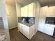 A corner of the kitchen is staged with white cabinetry, granite countertops, and stainless steel appliances at 729 Maple Ln, Brownsburg, IN 46112
