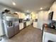 Spacious kitchen featuring stainless steel appliances, white cabinetry, and tile floors at 729 Maple Ln, Brownsburg, IN 46112