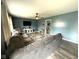 The living room showcases hardwood floors, cozy seating, a ceiling fan, and a mounted TV at 729 Maple Ln, Brownsburg, IN 46112