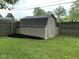 Fenced backyard featuring a storage shed with dark mulch surrounding it at 729 Maple Ln, Brownsburg, IN 46112
