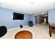 Open basement with TV area, armchair, coffee table, and access to other rooms at 7413 Misty Woods Ln, Indianapolis, IN 46237