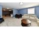 Open basement with billiard room, dining table, sitting area, and comfortable sofas at 7413 Misty Woods Ln, Indianapolis, IN 46237