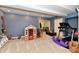 Carpeted playroom in the basement with playhouse, workout equipment, and shelving at 7413 Misty Woods Ln, Indianapolis, IN 46237