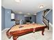 Open basement featuring a pool table, a wet bar, and stairwell access at 7413 Misty Woods Ln, Indianapolis, IN 46237